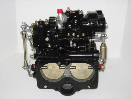 Black aircraft carburetor assembly showing dual throttle bores, linkages, and fuel metering components against a white background