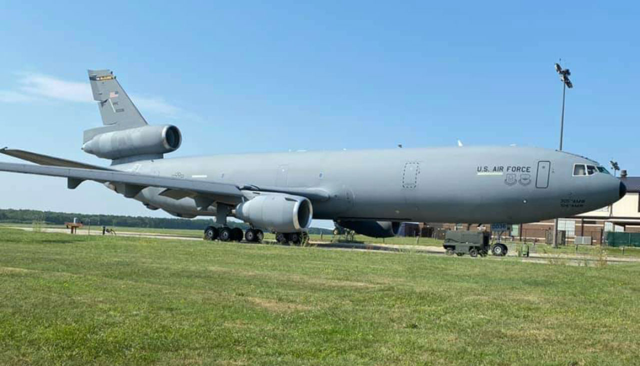 U.S. Air Force tanker aircraft parked on a grassy field at an airbase under a clear sky, promoting NAAS & Accessories career opportunities