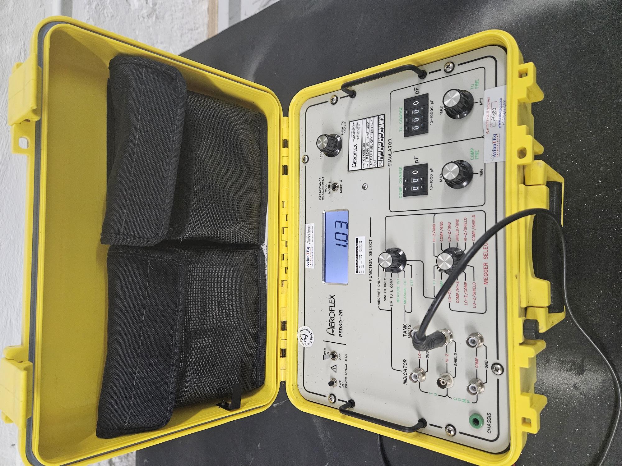 Aeroflex PSD60-2R fuel quantity indicator test set inside a yellow protective case showing a 1.03 reading