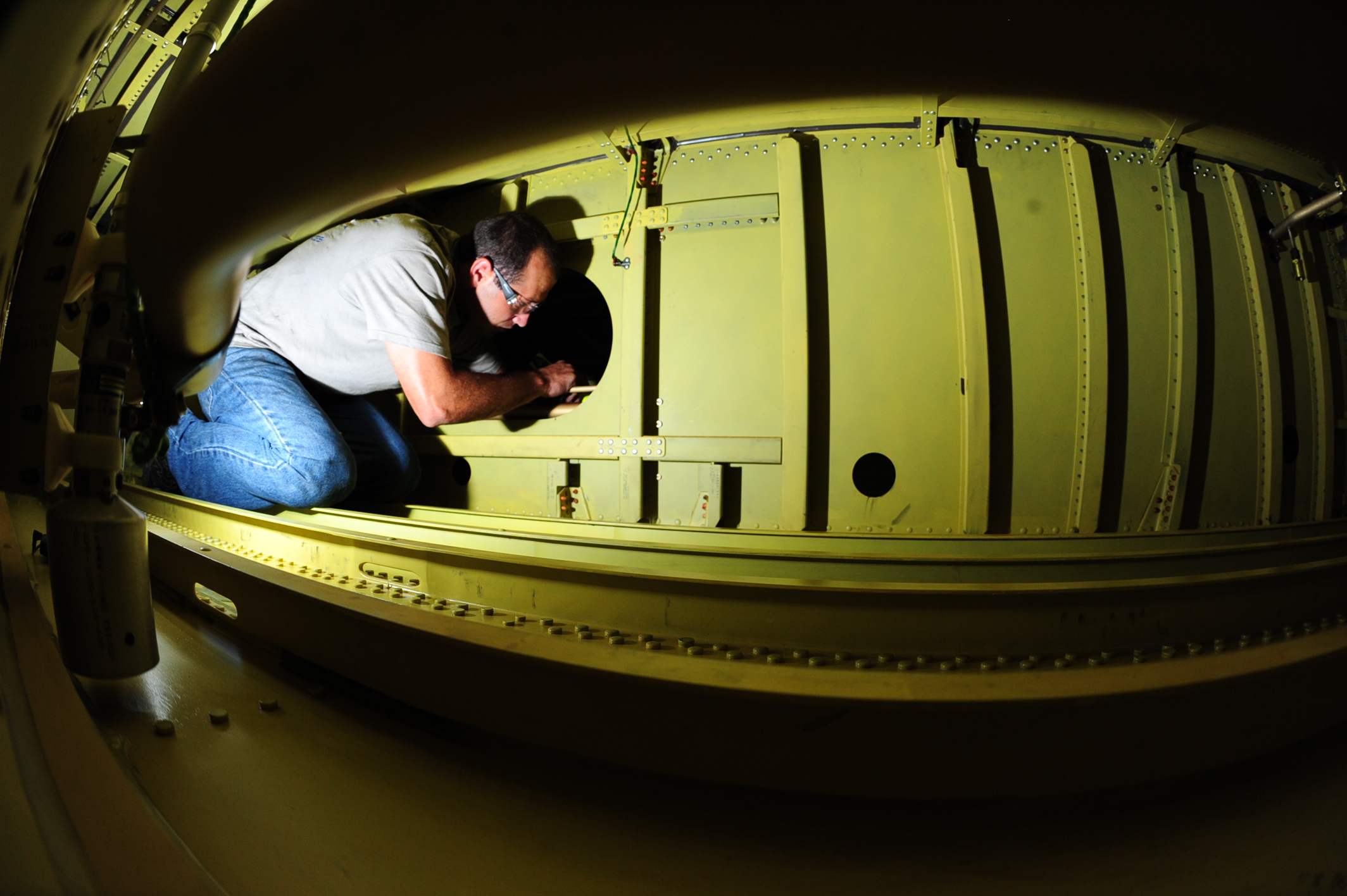 A FAA-Certified NAAS & Accessories technician performing a tank inpection.