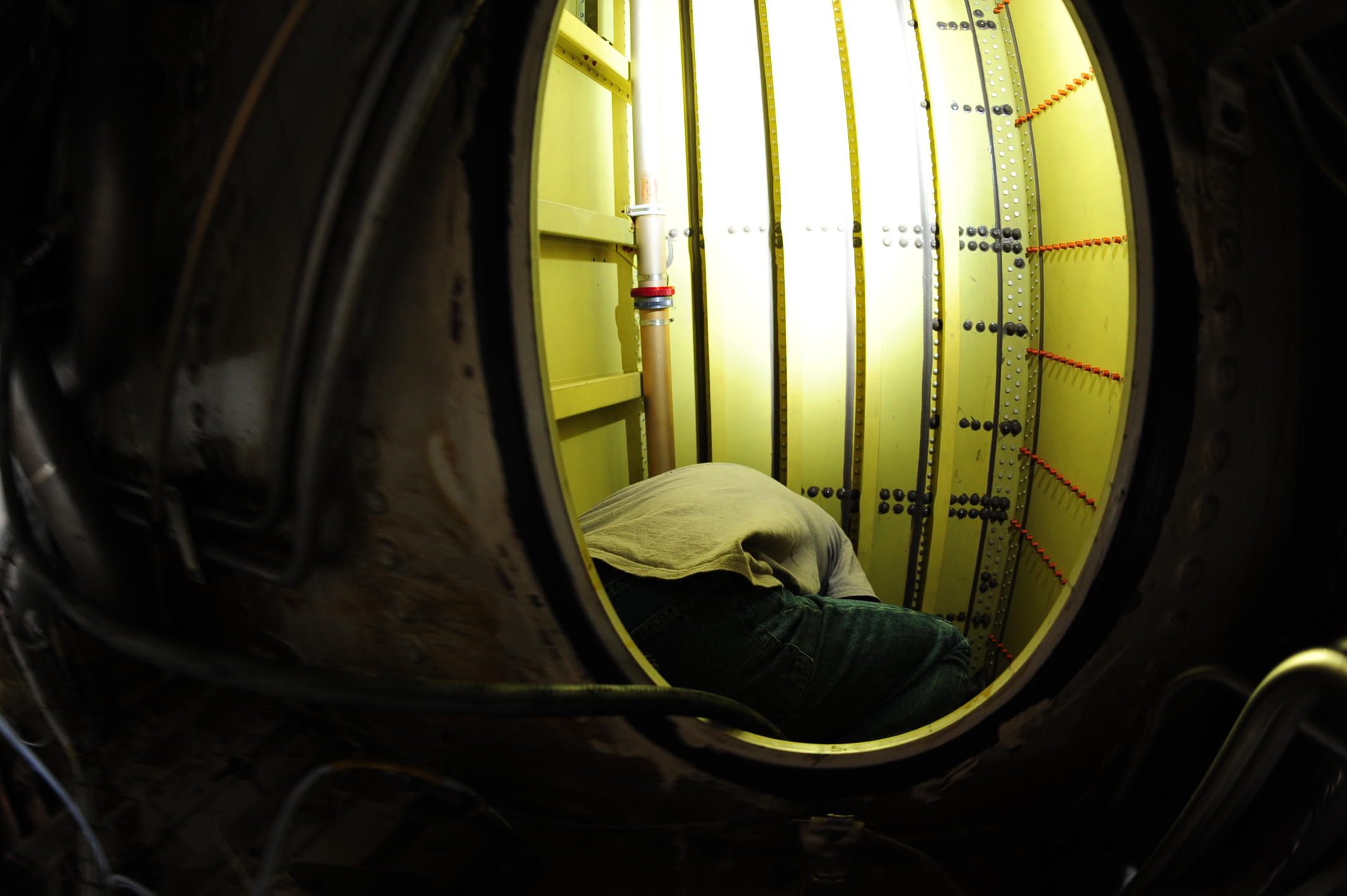 A FAA-Certified NAAS & Accessories technician performing a tank integrity inpection.