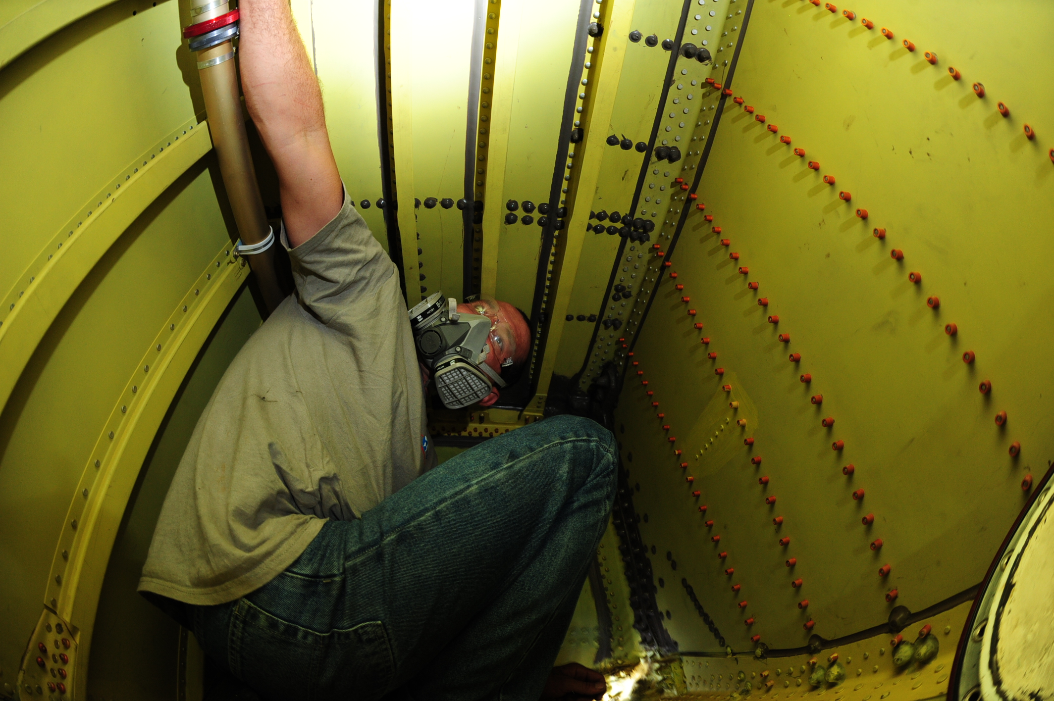 Technician performing structural repairs inside an aircraft fuel tank